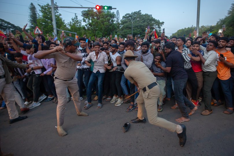 Police officers try to control fans of the Royal Challengers Bengaluru (RCB).