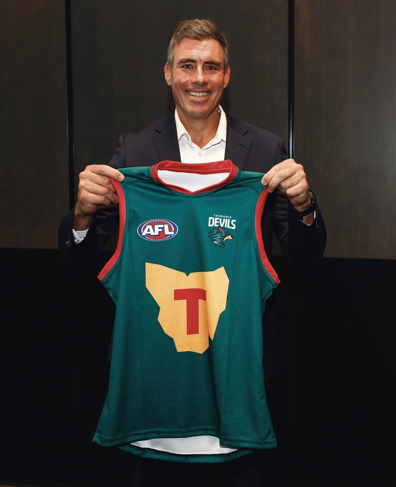 Matthew Richardson poses with The Tasmania Devils inaugural jumper during the Tasmania Football Club Launch in March 2024.