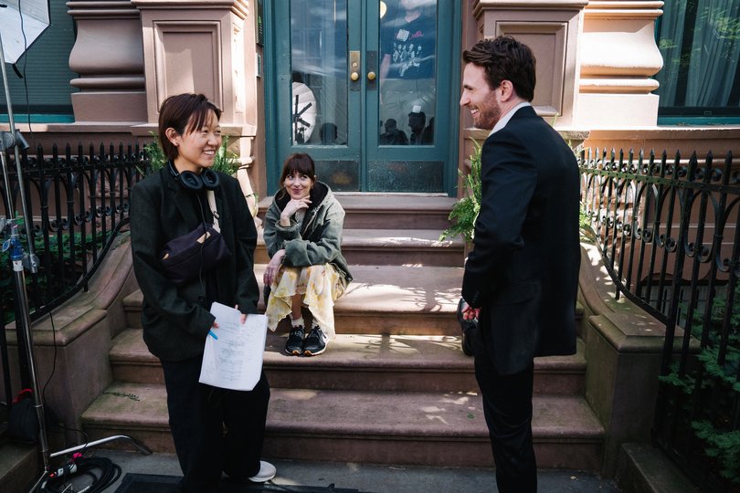 Celine Song on the set of Materialists with Dakota Johnson and Chris Evans.