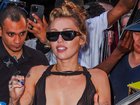 She paired the look with some chunky, black sunglasses and a plain gold necklace.