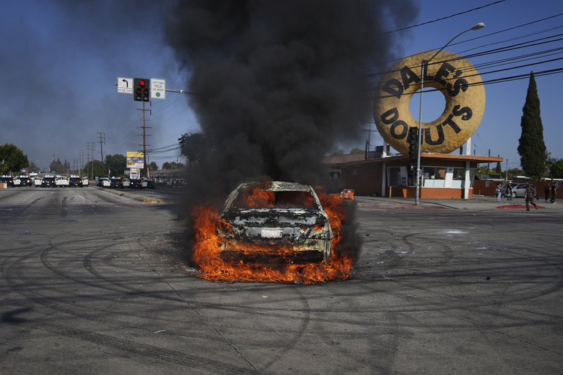 A car burns during a protest in Compton, Calif., Saturday, June 7, 2025, after federal immigration authorities conducted operations. (Eric Thayer)