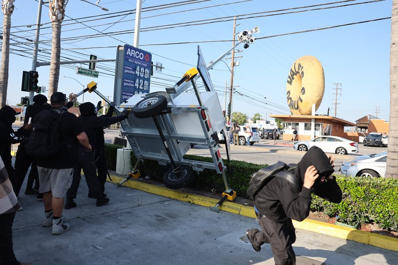 Protesters destroyed a mobile police surveillance post during a clash with federal agents after a raid was conducted by Immigration and Customs Enforcement.