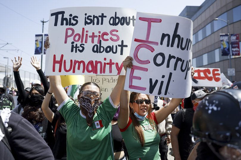 People protesting immigration enforcement policies gathered near the Edward R. Roybal Federal Building in Los Angeles.