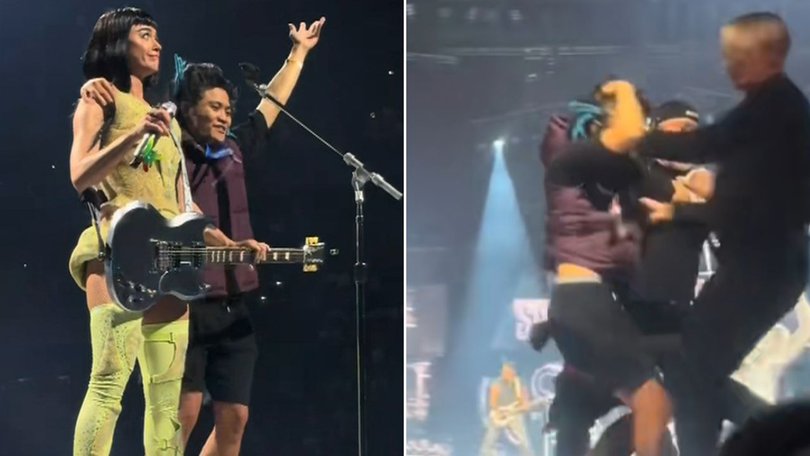 Johnson Wen managed to get past security and ran up behind Katy Perry while she was singing her hit song Hot N Cold.