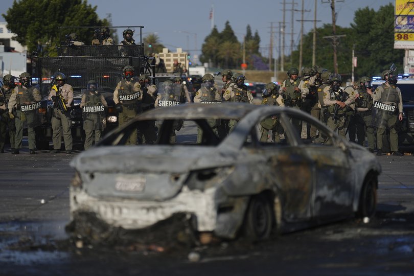 Los Angeles County Sheriffs stand in line during a protest in Compton.