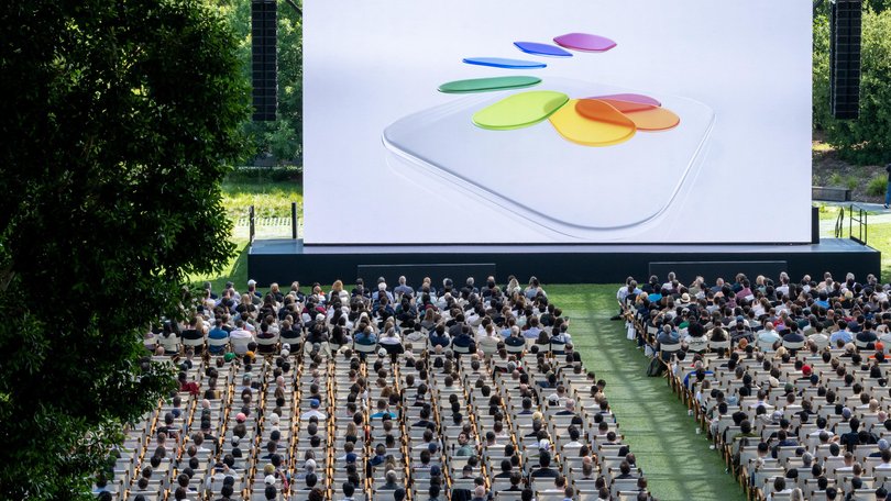 Attendees watch the keynote address during the Apple Worldwide Developers Conference (WWDC) at Apple Park campus in Cupertino, California, US, on Monday, June 9, 2025. Apple Inc. unveiled a new operating system interface called Liquid Glass.