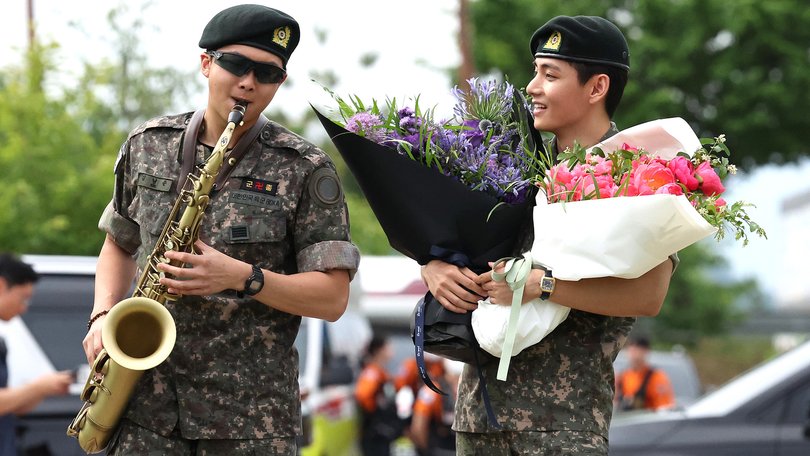 BTS members RM and V play to the crowd after the military discharge.