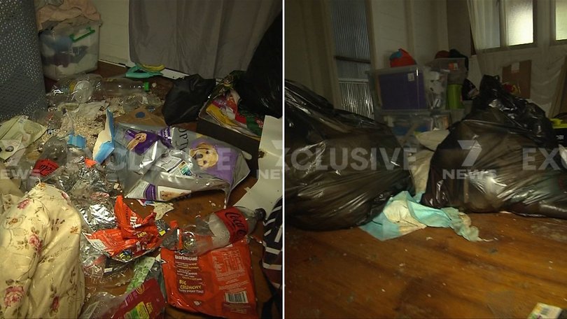 Footage taken by 7NEWS shows the floor of the home covered in rubbish, clothing and dog faeces.