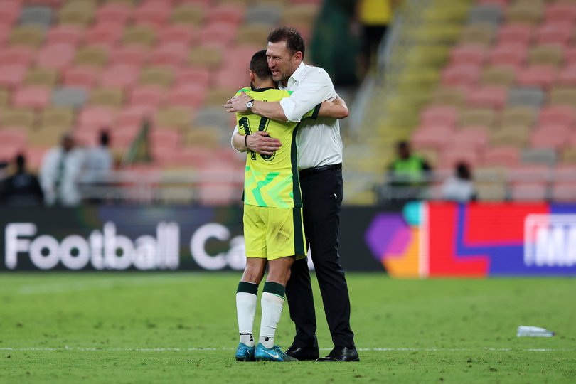 Aziz Behich embraces Tony Popovic.