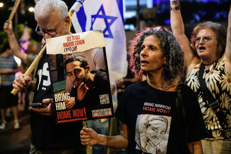 icky Cohen, mother of Israeli hostage Nimrod Cohen holds a placard with Nimrod's photo during a demonstration against Prime Minister Benjamin Netanyahu.
