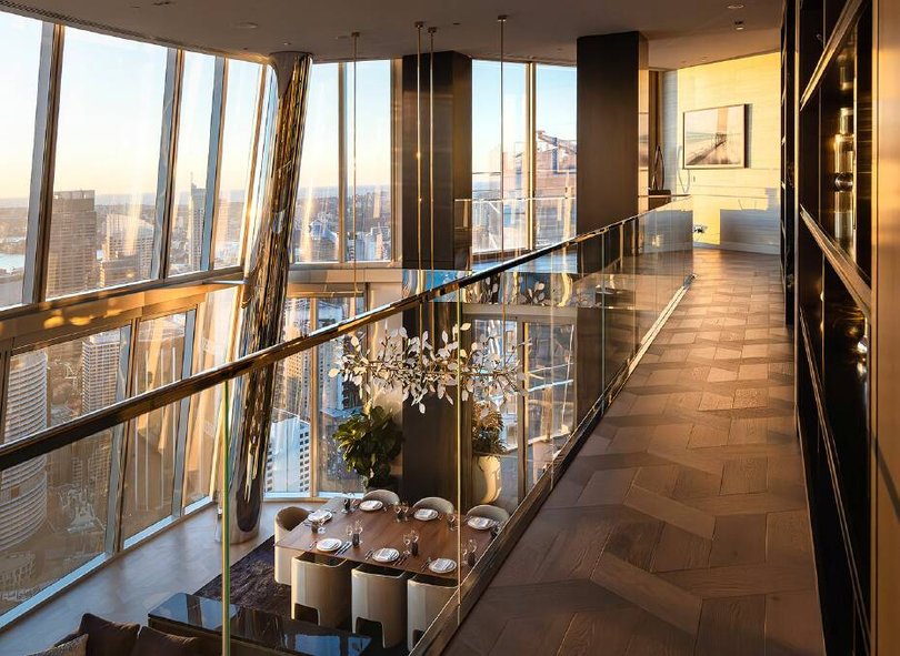 The main entertaining area features double-height ceilings and walls of windows.