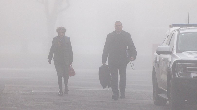 Crown prosecutor Nanette Rogers (left) and Detective leading Senior Constable Stephen Eppingstall arrive though the fog on Thursday. Picture: NewsWire / Diego Fedele