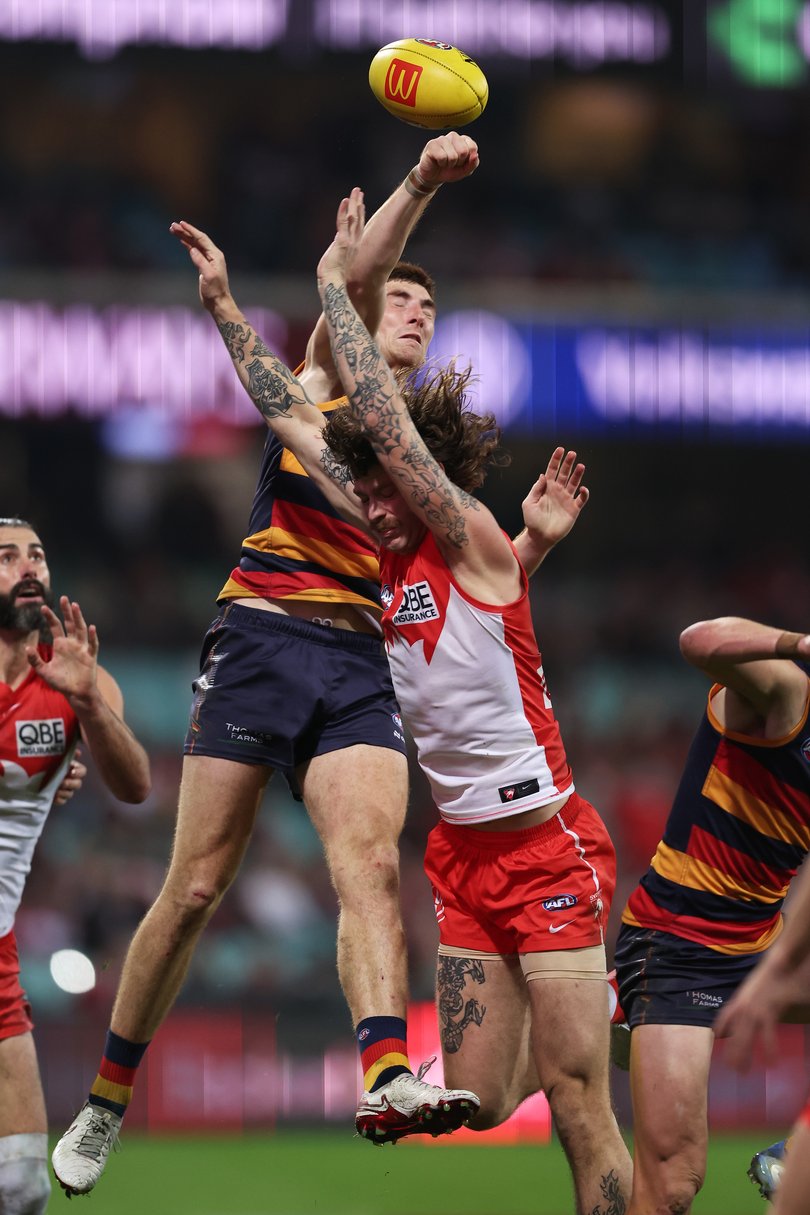 Peter Ladhams and Mark Keane compete for the ball.