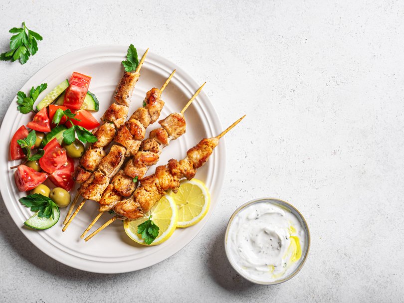 Grilled chicken kebabs, greek salad and potato wedges are a healthy option.