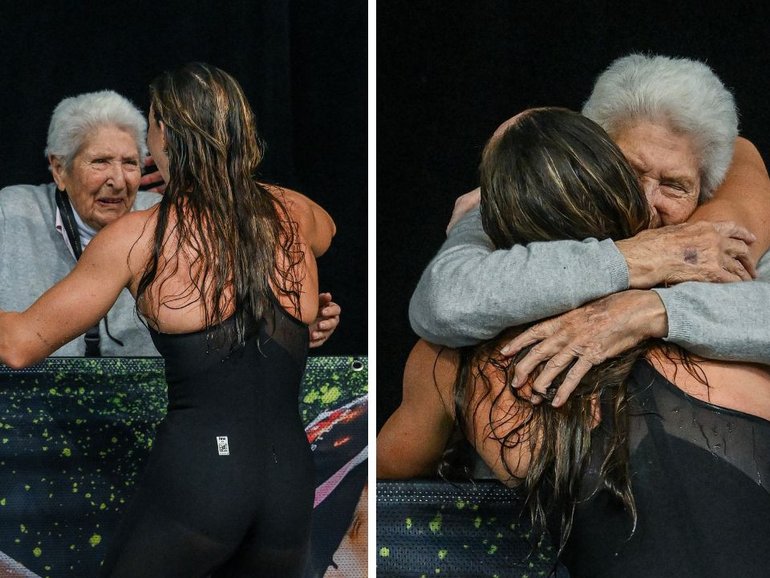 Dawn Fraser hugs goddaughter Lani Pallister after the record-breaking swim. 