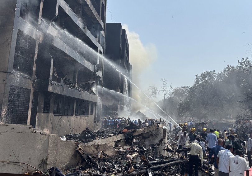 Firefighters work at the site of a plane crash near Sardar Vallabhbhai Patel International Airport in Ahmedabad, Gujarat, western India, 12 June 2025.