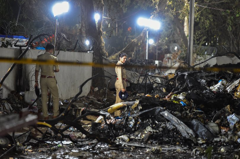 Police investigate site of where the Air India flight crashed shortly after takeoff on June 12, 2025 in Ahmedabad, India.