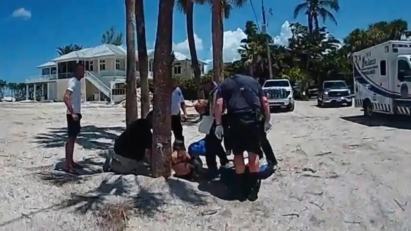 Police body camera video captured first responders helping the young shark attack victim.