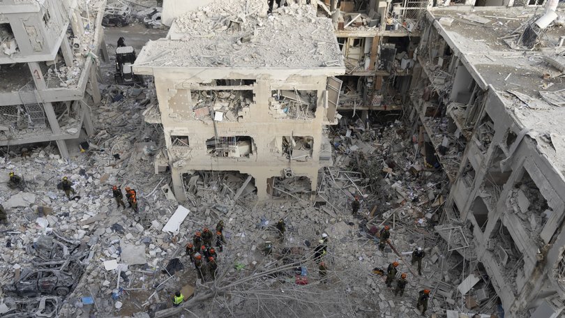 Emergency and rescue soldiers search for trapped people around heavily damaged buildings after an overnight missile strike from Iran in Bat Yam Israel.