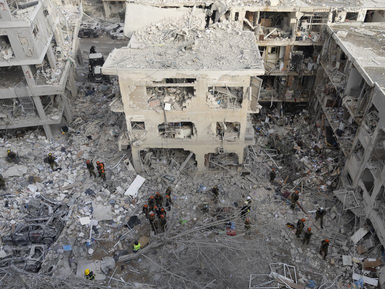 Emergency and rescue soldiers search for trapped people around heavily damaged buildings after an overnight missile strike from Iran in Bat Yam Israel.
