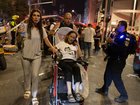Israelis move an injured Israeli woman to an ambulance near a building hit by a ballistic missile launched from Iran in Bat Yam, Israel, on Sunday, June 15, 2025.  