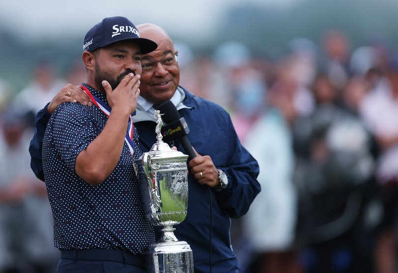 J.J. Spaun celebrates with the trophy as he talks with NBC Sports broadcaster Mike Tirico.