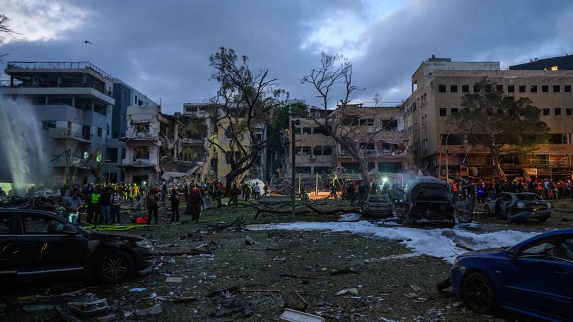 Israeli rescue workers and security personnel inspect and clear the buildings and area hit by an Iranian rocket on June 16, 2025 in Central Tel Aviv, Israel.