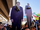 Supporters of Iraqi pro-Iran groups hold cutouts of US President Donald Trump with a shoe around the neck during a protest in support of Iran, in Baghdad near the green zone, the ultra secured neighbourhood hosting the US embassy, on June 16, 2025, amid the Israel-Iran escalating conflict. (Photo by AHMAD AL-RUBAYE / AFP)