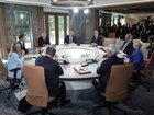 L-R Clockwise) Japan's Prime Minister Shigeru Ishiba, Italy's Prime Minister Giorgia Meloni, French President Emmanuel Macron, Canadian Prime Minister Mark Carney, US President Donald Trump, British Prime Minister Keir Starmer, German Chancellor Friedrich Merz, European Commission President Ursula Von der Leyen, and European Council President António Costa attend a working session during the G7 Leaders Summit on June 15, 2025 in Kananaskis, Canada.