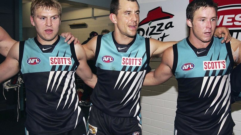 ane Cornes, Warren Tredrea and Stuart Dew of Port sing the club song after winning the AFL Round 15 match between the Port Adelaide Power and the Melbourne Demons at AAMI Stadium July 9, 2005.