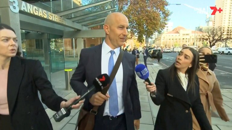 Warren Tredrea faced questions outside court. 