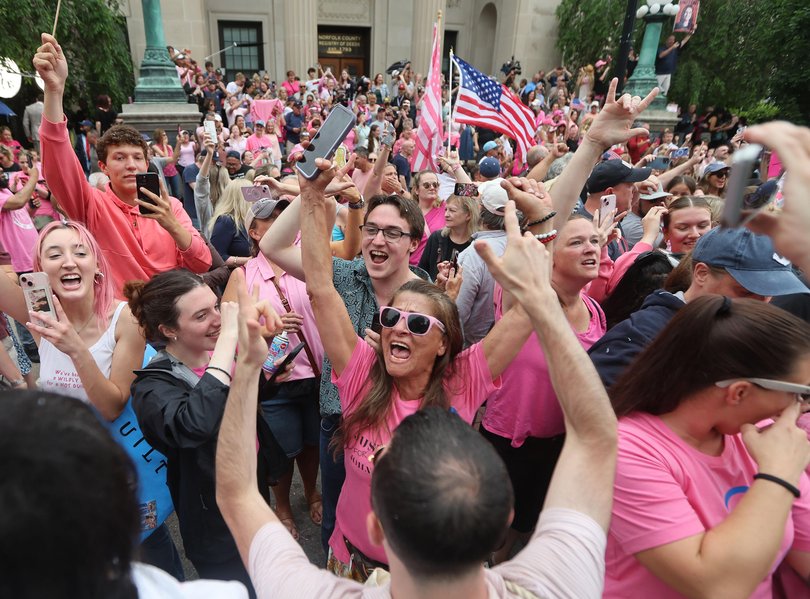 Supporters cheer as the verdicts are read as she is acquitted on many of the charges against her on June 18.