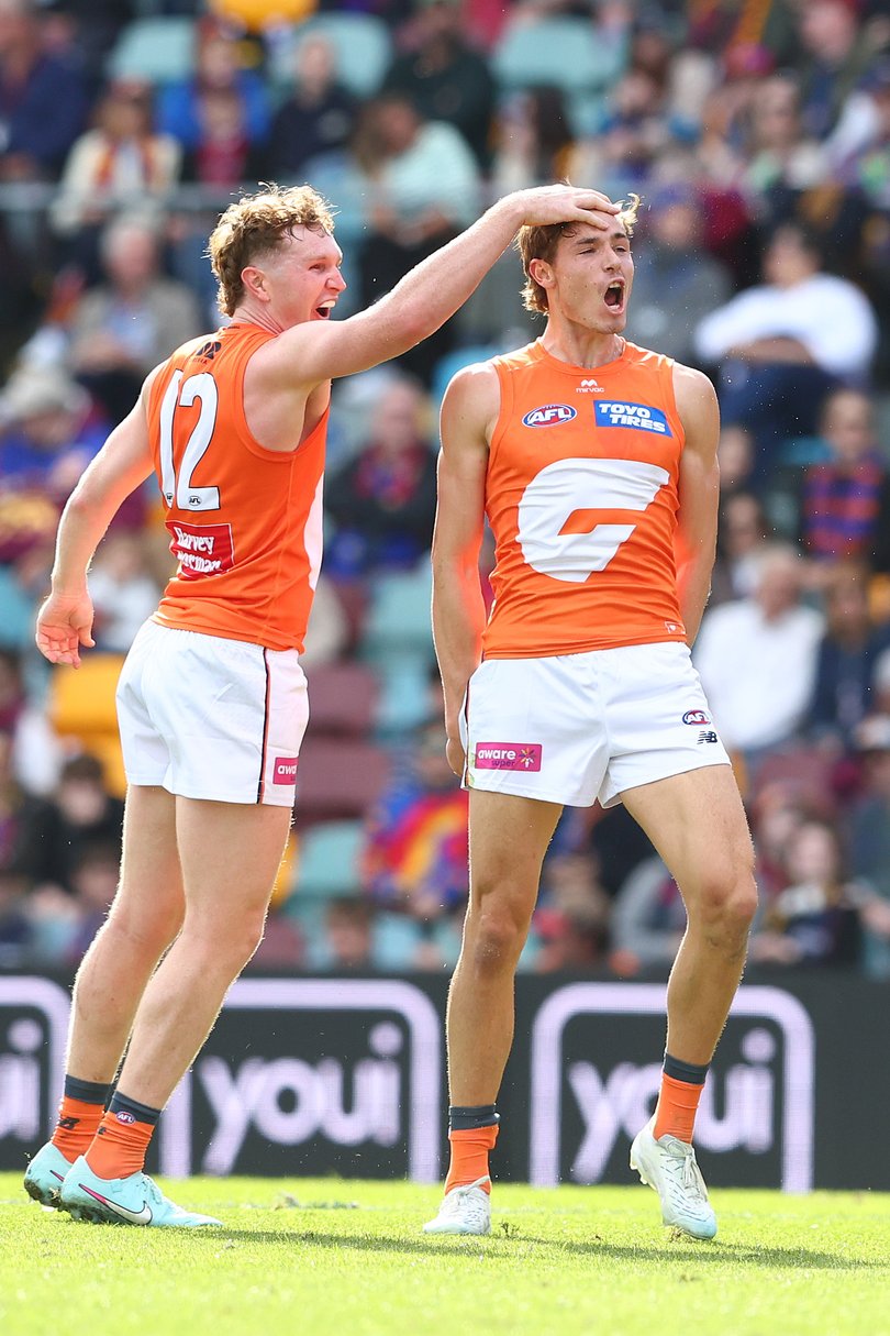 Aaron Cadman (r) celebrates one of his five goals against the Brisbane Lions.