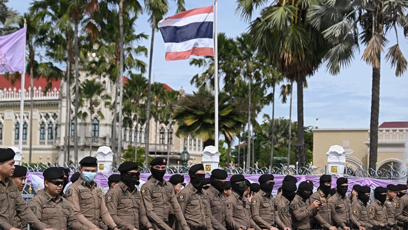 Thai police stand outside the Government House in Bangkok on June 19, 2025, in anticipation of Thai royalists protesting to call for the government's resignation.