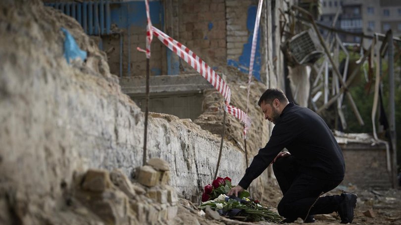President Volodymyr Zelenskiy visited destroyed Kyiv apartment building where 23 people died. (AP PHOTO)