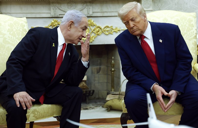 Israeli Prime Minister Benjamin talks to US President Donald Trump during a meeting in the Oval Office of the White House in April 2025.