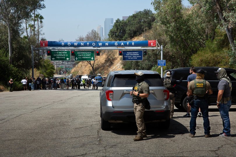 Border Patrol agents stand at Gate E of Dodger Stadium in Los Angeles. The Dodgers denied them access, stating that immigration agents are not allowed on the property.