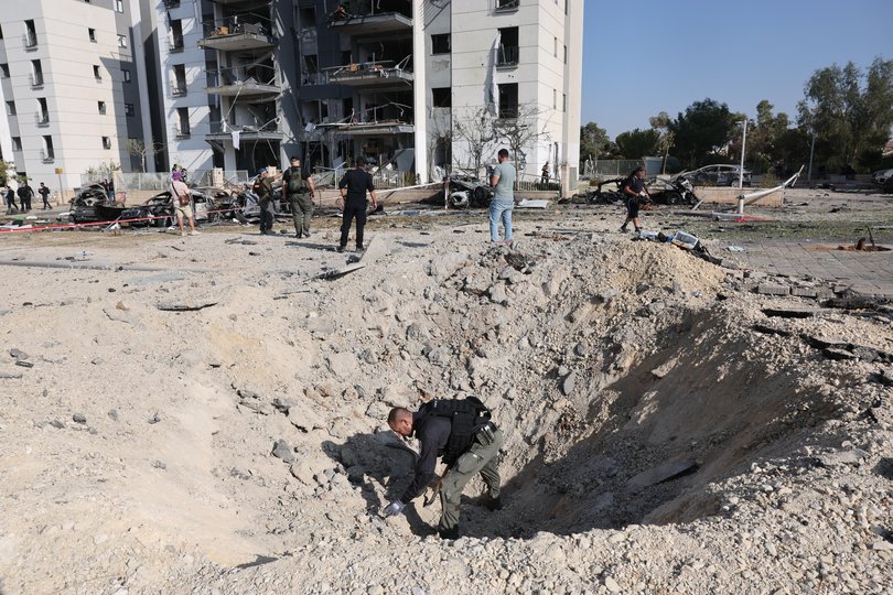 Police bomb disposal units search for remains at the site where Iranian ballistic missiles struck residential buildings in Beersheba.