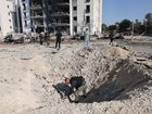 Police bomb disposal teams search for remains of an Iranian ballistic missiles in Beersheva.