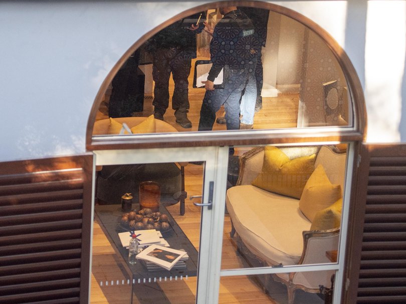 Officers were seen inside the multimillion-dollar home on Friday.
