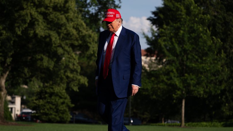 President Donald Trump returns to the White House before a meeting with his National Security Council.