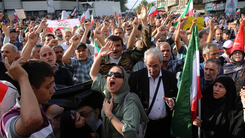 Crowds holding Iranian flags gather in the Revolution Square in the capital Tehran to protest the US attacks on three nuclear facilities in Iran/.