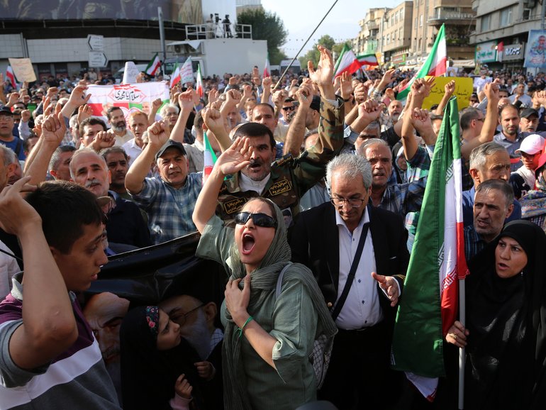 Crowds holding Iranian flags gather in the Revolution Square in the capital Tehran to protest the US attacks on three nuclear facilities in Iran/.