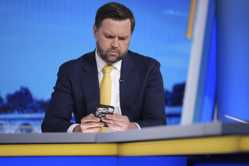Vice President JD Vance checks his phone before his interview with Bret Baier, right, on FOX News Channel’s Special Report with Bret Baier at the FOX News bureau in Washington, Monday, June 23, 2025.(AP Photo/J. Scott Applewhite)