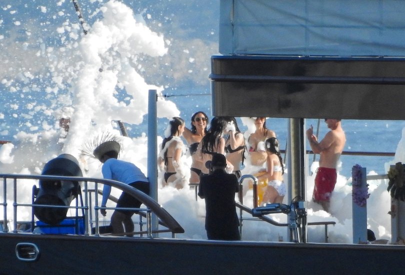 Images showed Bezos and Sánchez embracing in thick, soap-filled foam on the yacht’s deck.