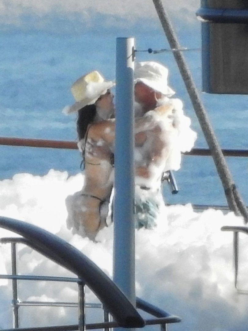 The billionaire and his soon-to-be wife sudded up, embracing in the soapy foam.