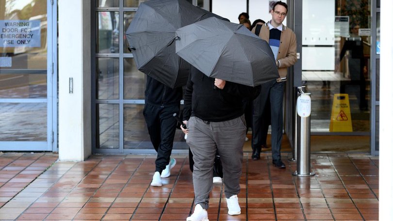 Adam Abdul-Hamid's family shielded themselves with umbrellas and swore at the media as they left court.