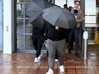 Adam Abdul-Hamid's family shielded themselves with umbrellas and swore at the media as they left court.