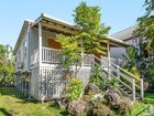 This three-bedroom cottage with high ceillings and front and rear decks is going up for auction with no reserve.