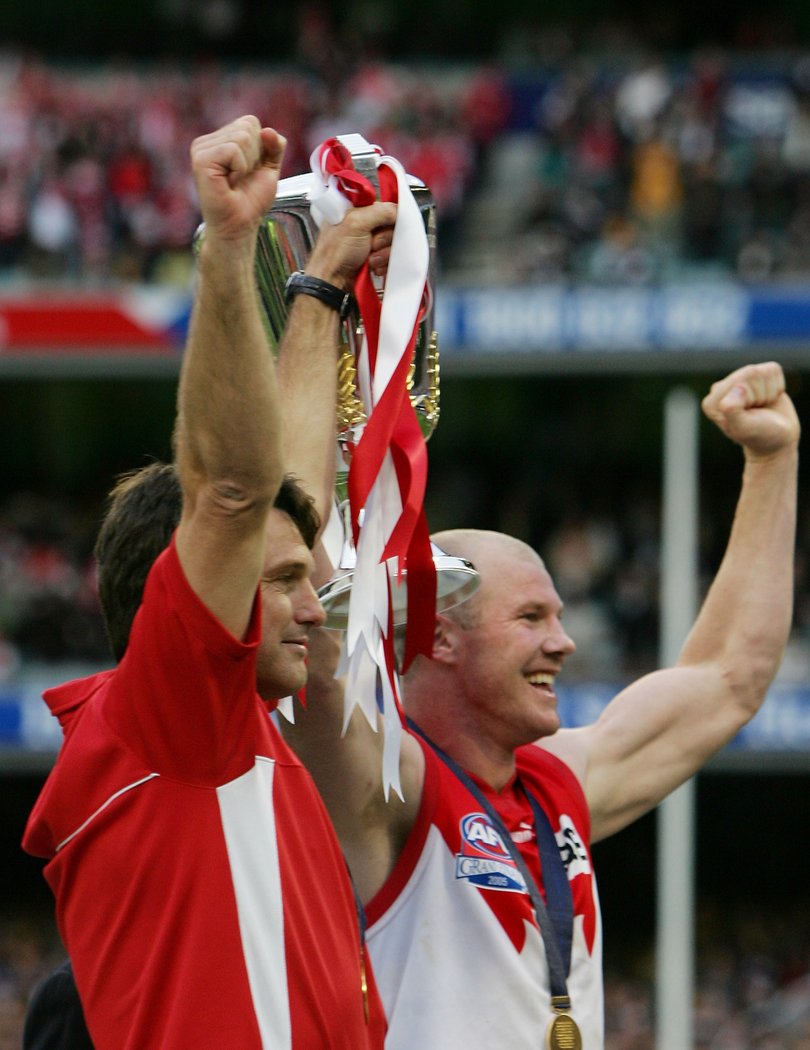 Paul Roos and Swans captain Barry Hall hold the trophy aloft.